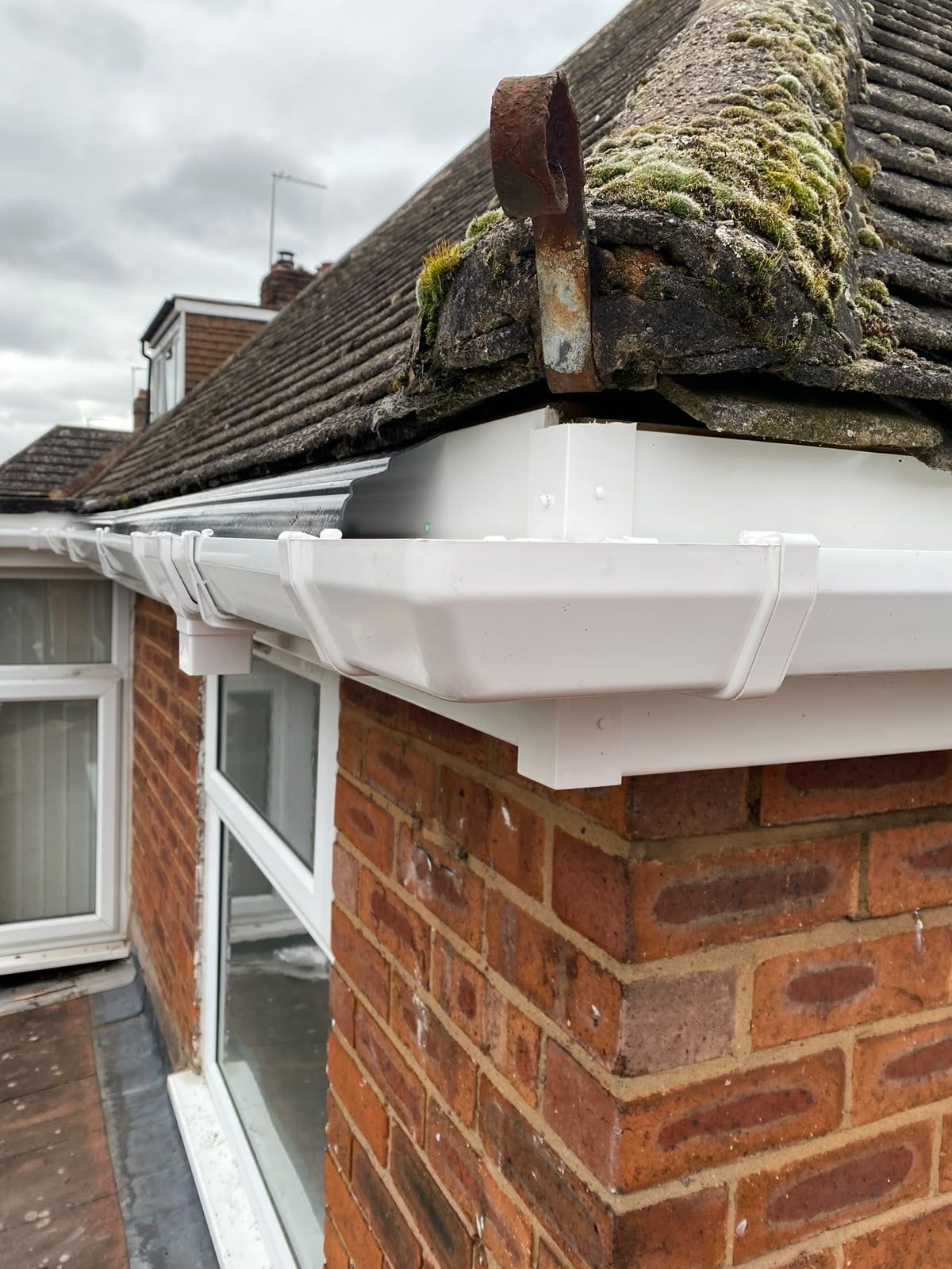 New white fascia and gutter fitted under a tiled roof
